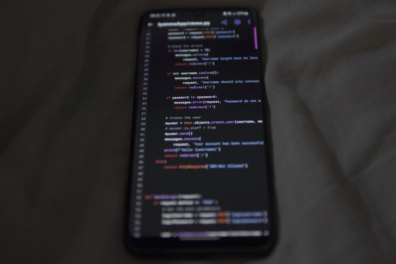 hero-01 Close-up of a smartphone showing Python code on the display, showcasing coding and technology.